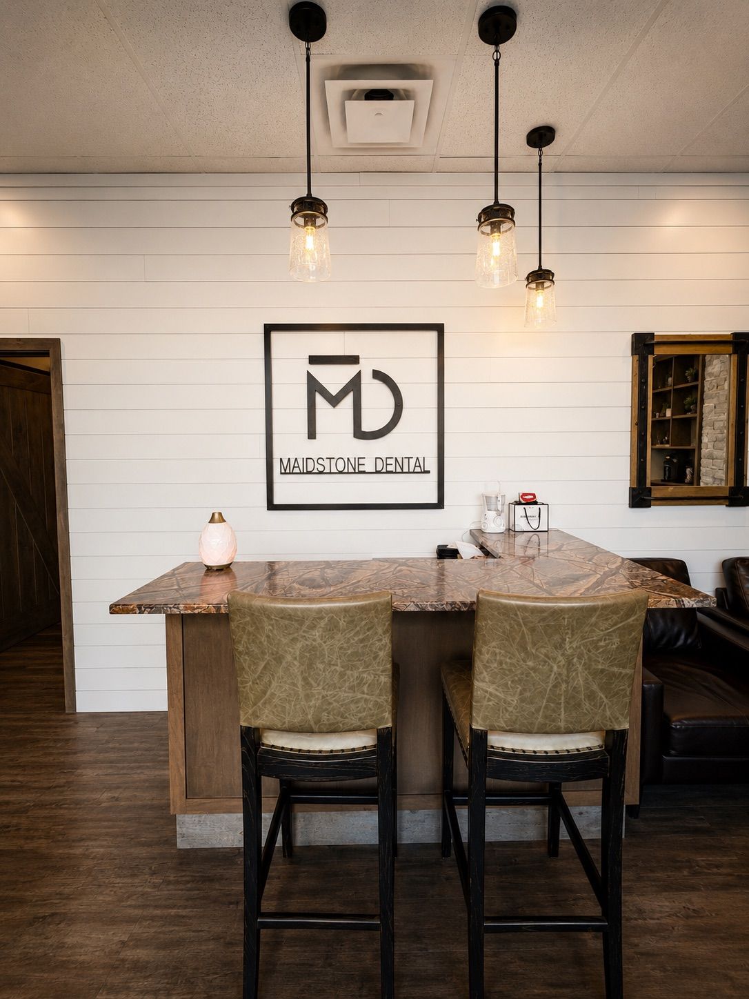 Reception counter and Maidstone Dental logo in the waiting lounge