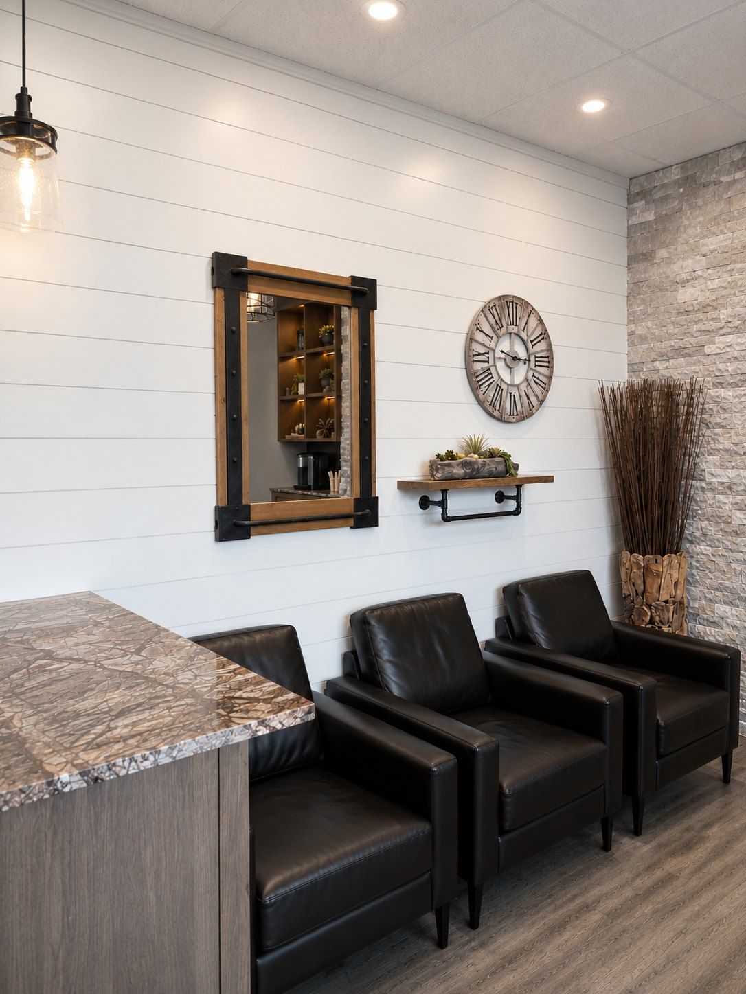 Waiting lounge at Maidstone Dental with leather chairs and shiplap walls