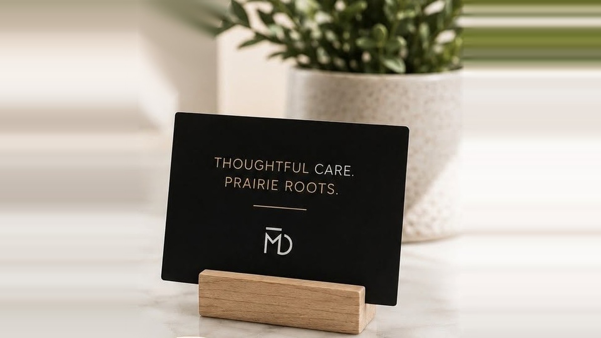Maidstone Dental card on the counter reading Thoughtful Care. Prairie Roots.