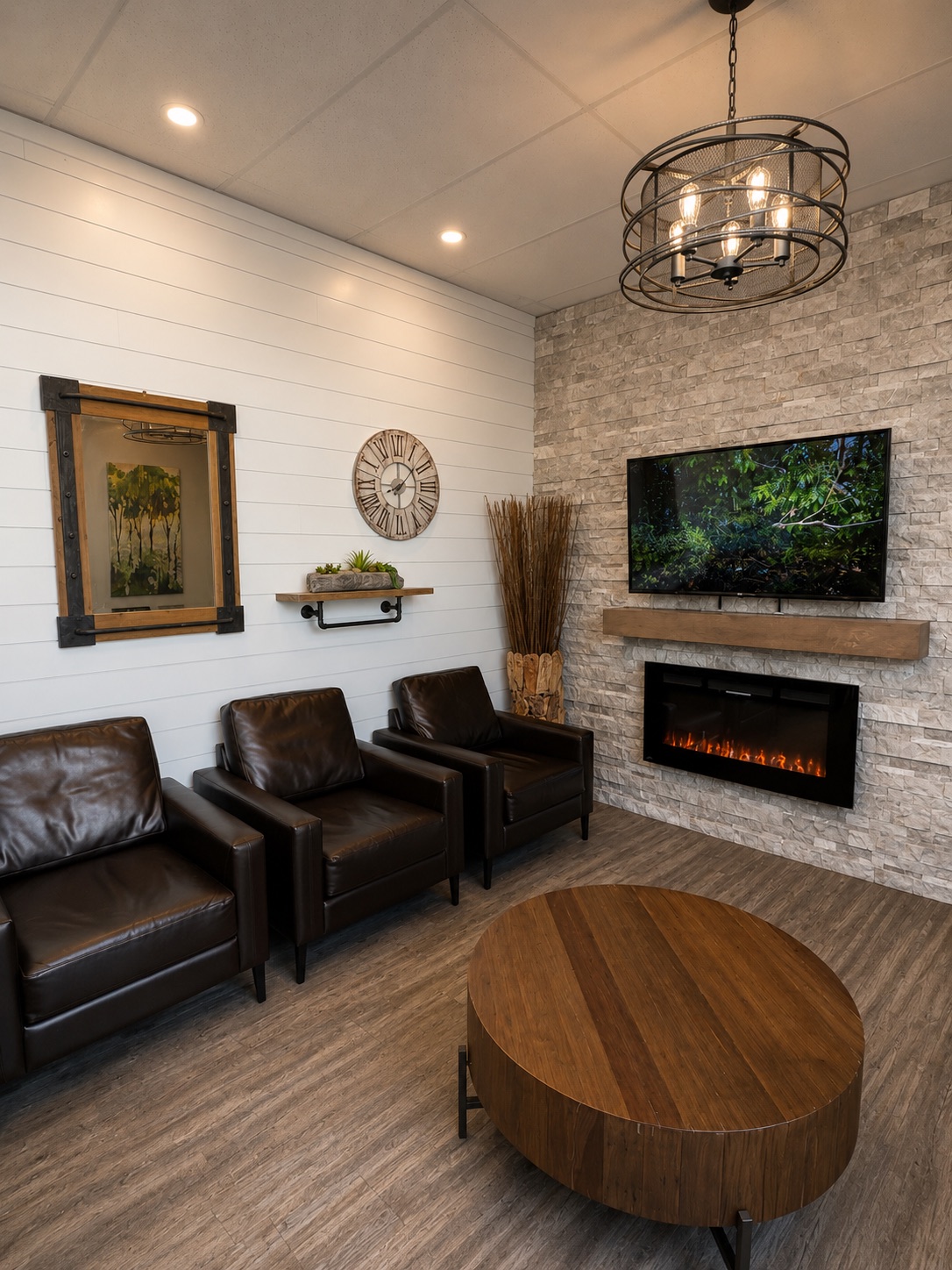 Waiting lounge at Maidstone Dental with seating, fireplace, and television